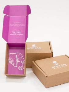 three African Coffee Club mailer boxes with pink interior and image of an elephant on the base