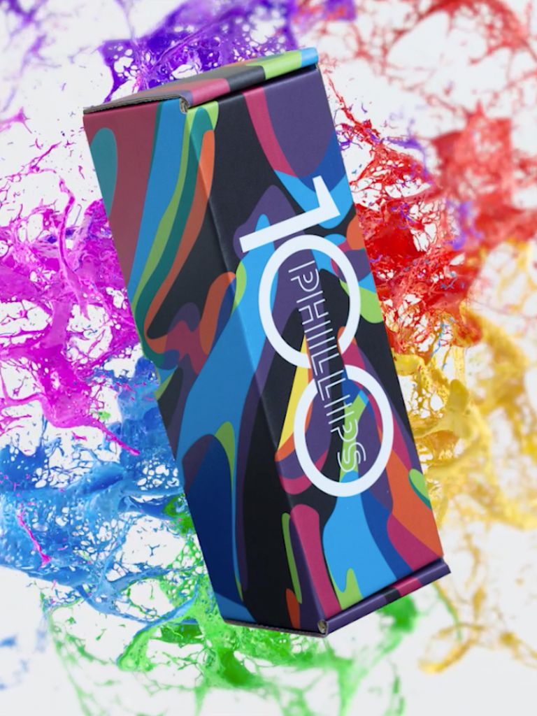 a box with brightly neon colored shapes on it and paint splashing behind it